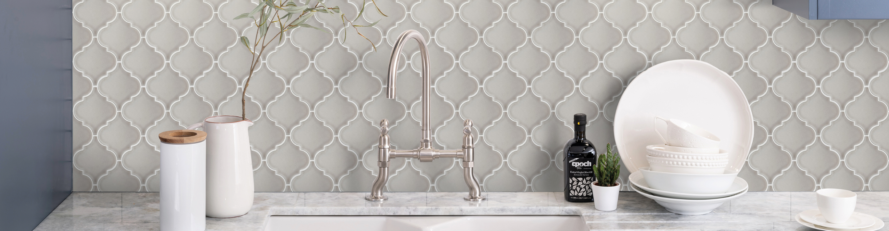 Grey backsplash tile over country style kitchen sink, 